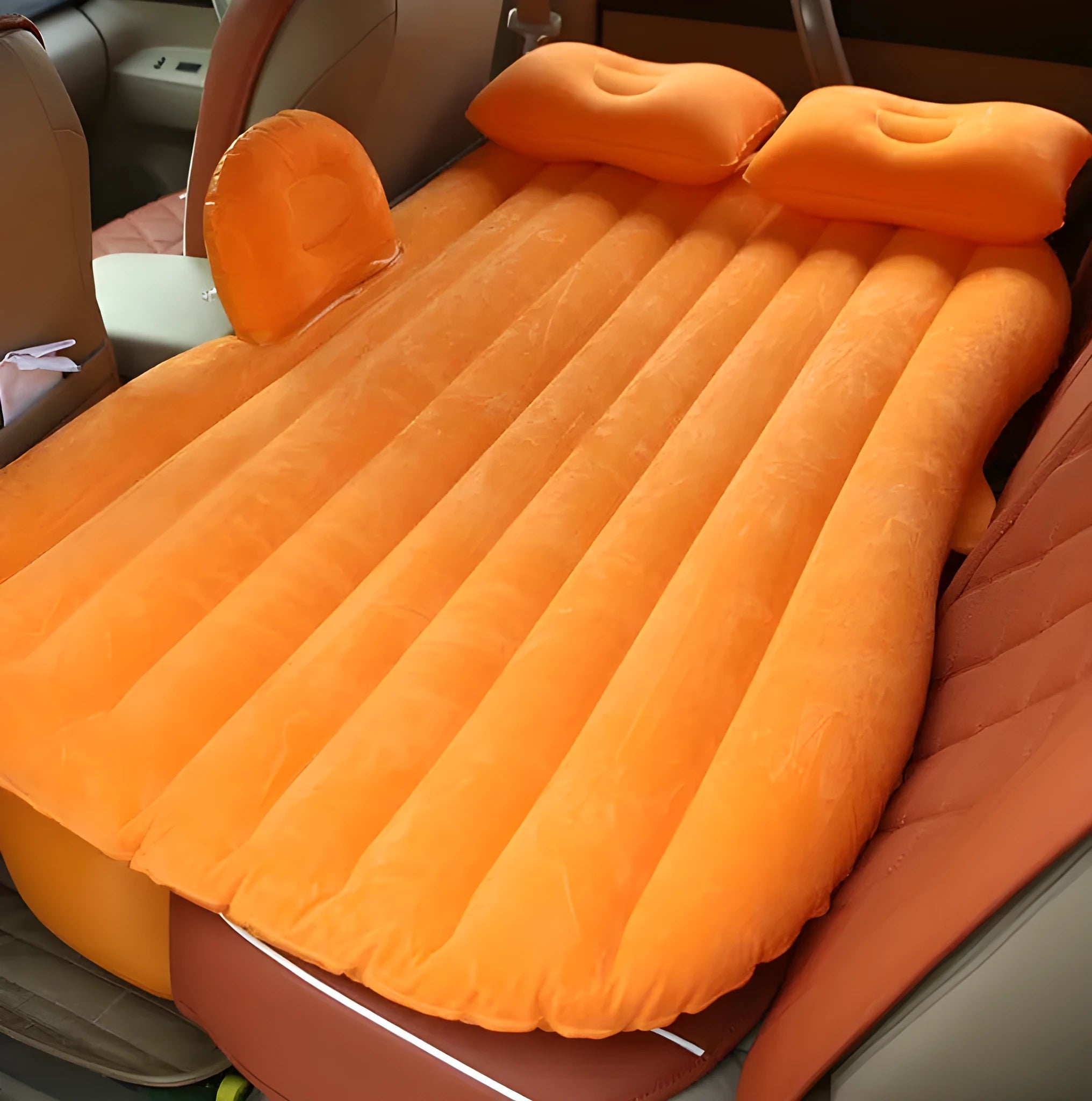 Black thickened flocking inflatable car bed set up in a vehicle with pillows.