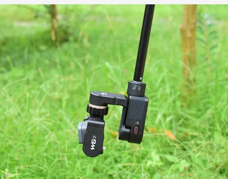 Retractable metal selfie stick with rubberised grip handle and smartphone mount, shown extended.