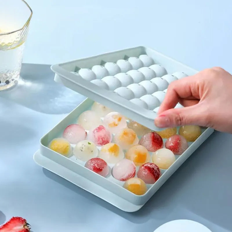 Blue silicone ice cube tray with lid showing 33 round grids for making ice.