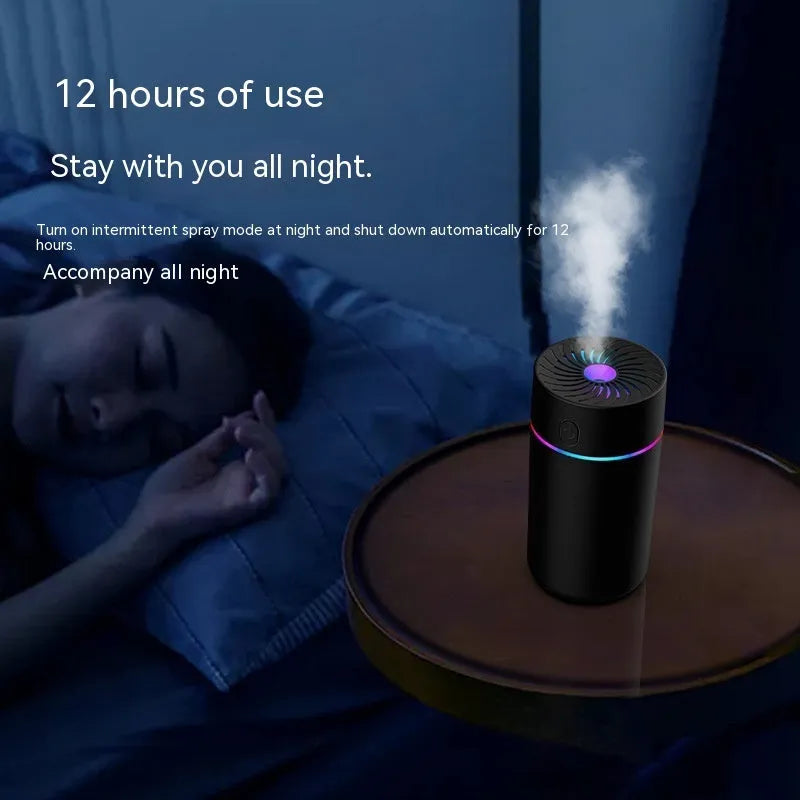 A small white or black USB car humidifier with aromatherapy function on a car dashboard.