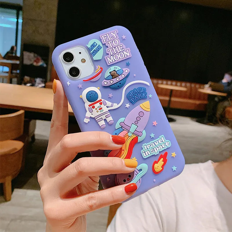 Purple silicone iPhone case featuring astronaut cartoon design for multiple model compatibility