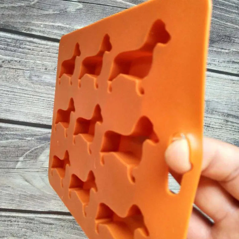 Orange silicone ice mold producing animal-shaped ice cubes for creative drinks