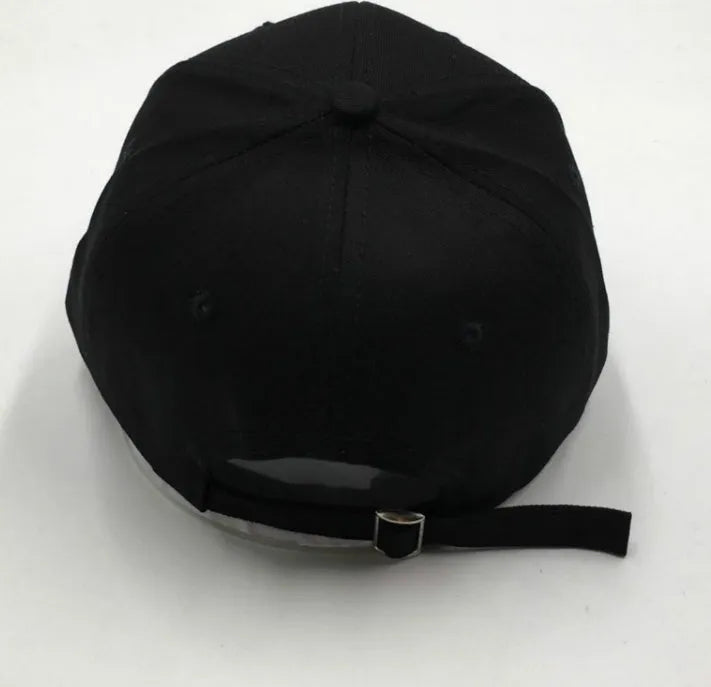 Letter embroidered cotton baseball cap in black with curved brim on white background