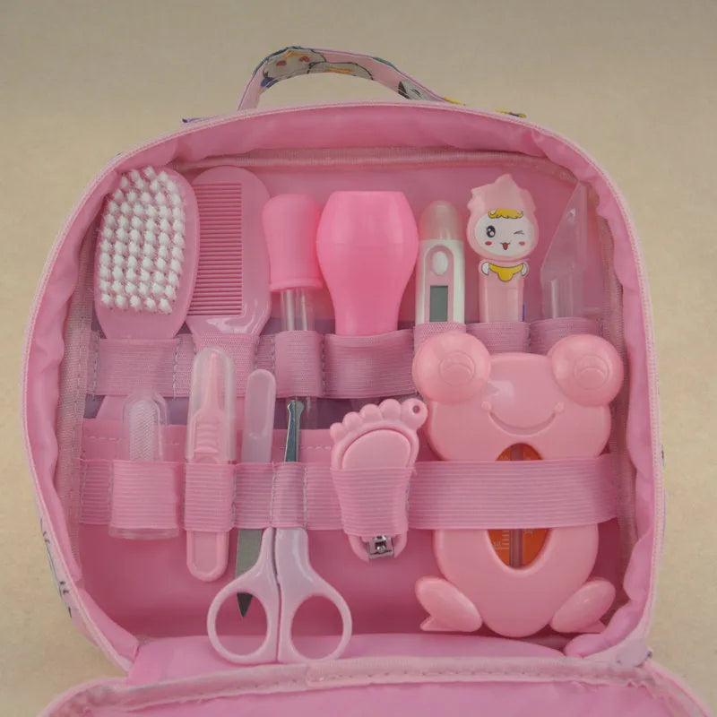 Roadfisher Newborn Baby Care Kit in pink or blue, showing safety scissors, brush, comb, thermometer, and syringe.