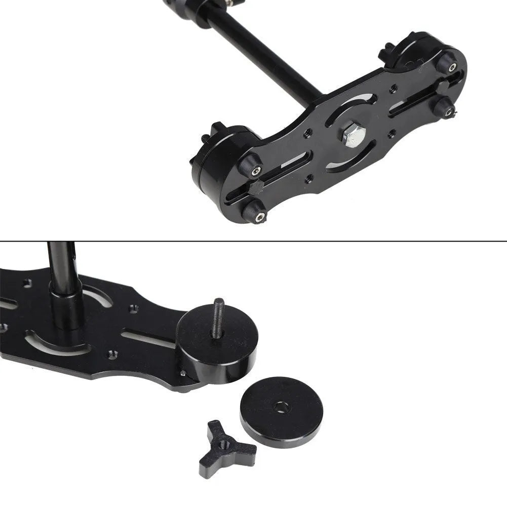 Black aluminium handheld camera stabiliser with adjustable height on a table.