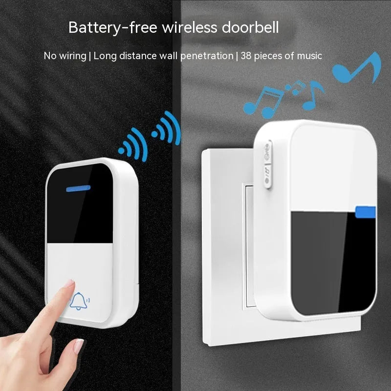 White self-powered wireless doorbell transmitter and plug-in receiver on a wooden table.