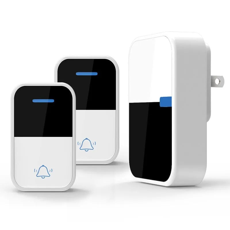 White self-powered wireless doorbell transmitter and plug-in receiver on a wooden table.
