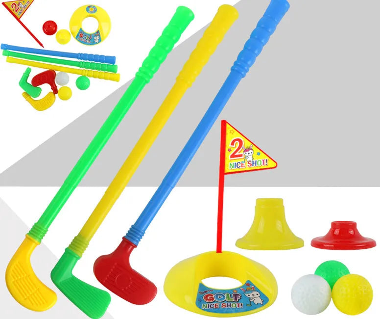 Children's golf set with three clubs, three golf balls, a hole, a flag, and two tees on grass