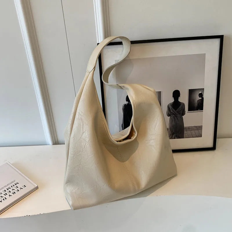Soft PU leather large capacity shoulder bag in multiple colours with front sandwich pocket.