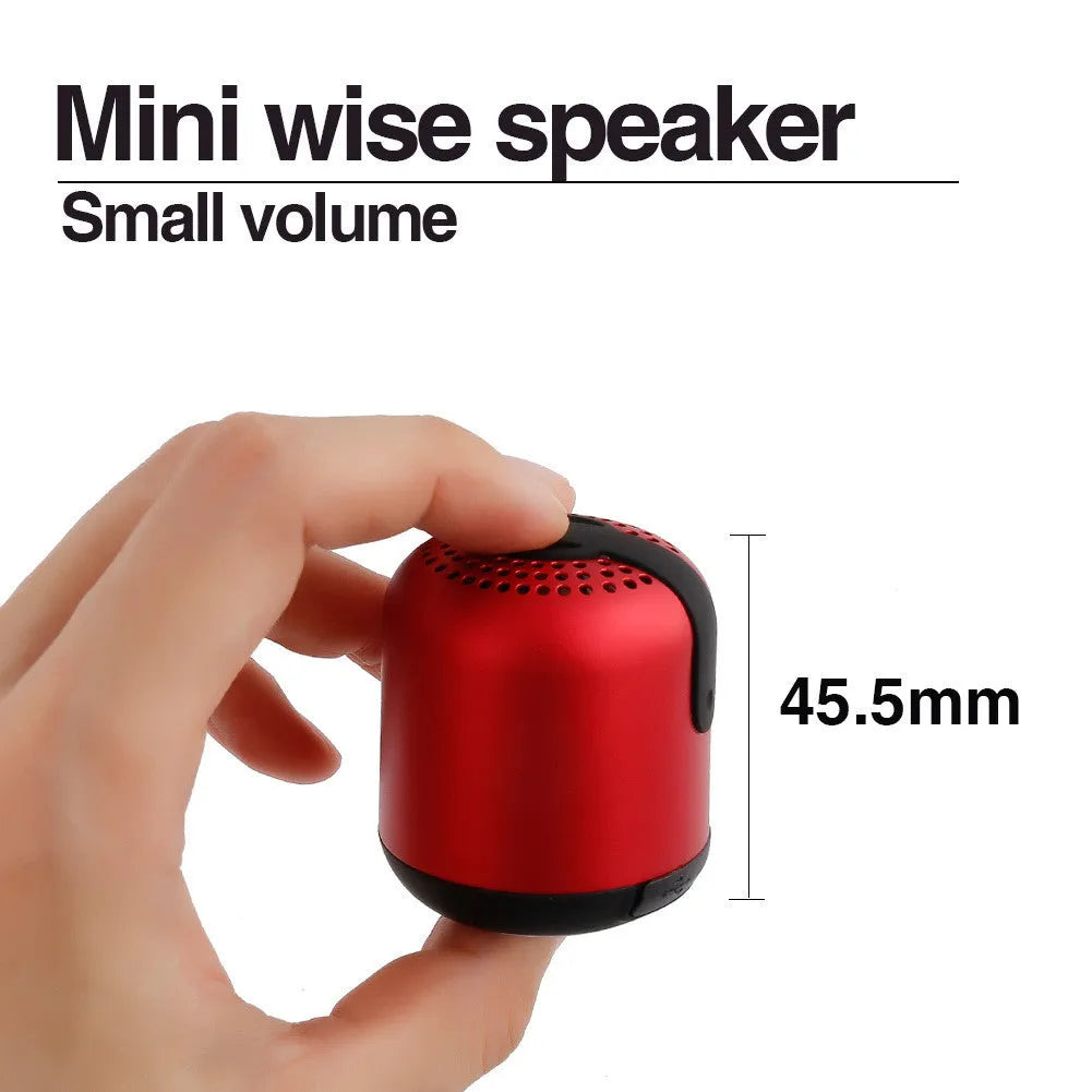 Hieha XQ11 cylindrical portable Bluetooth speaker in silver colour on a table.