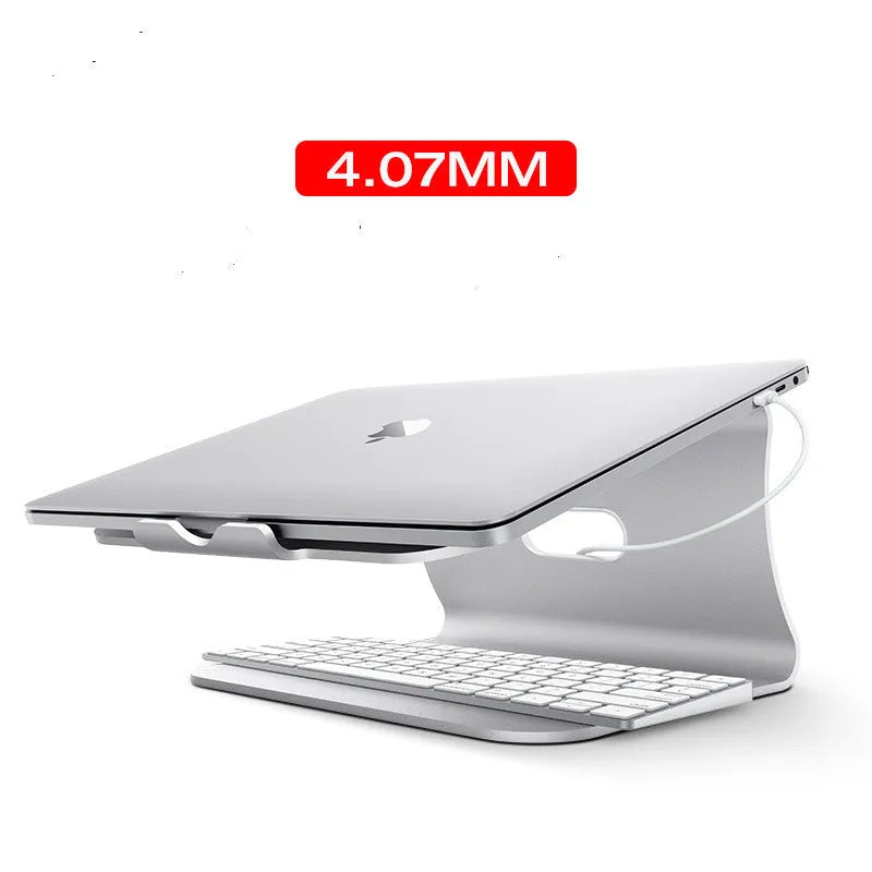 Grey aluminium laptop cooling stand with a thick 4.07mm frame and a rotating base on a wooden desk.