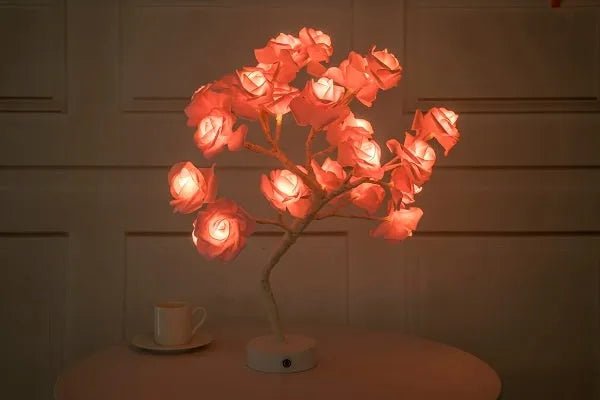 White and red rose flower shaped USB battery LED table lamp with warm white light on a table