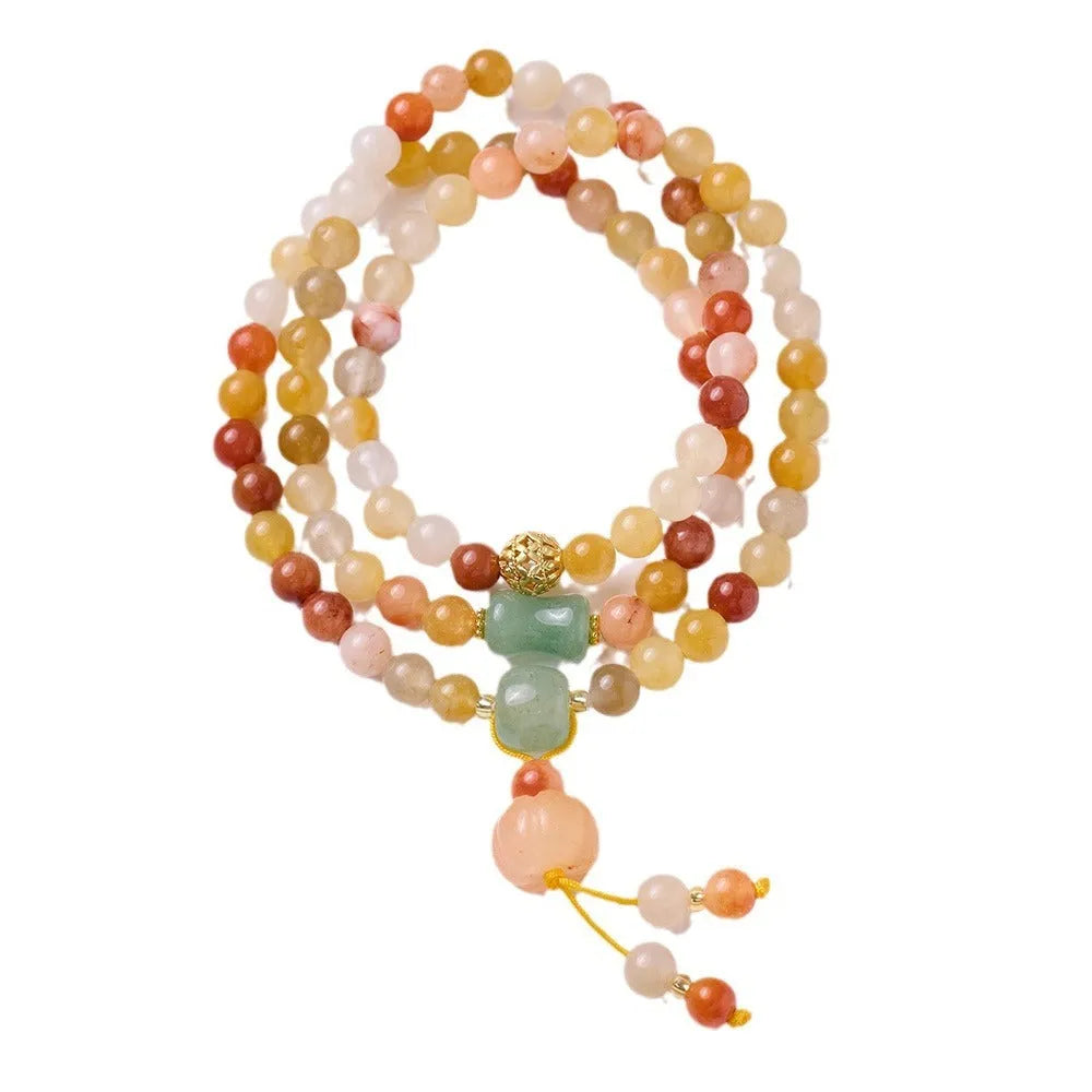 Women's Jinsi Jade bracelet with pumpkin tassel on a 14-16cm wrist.