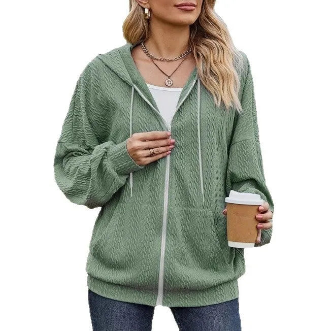 Green women's hooded zip-up coat with a loose fit, long sleeves, and a front zipper on a neutral background.