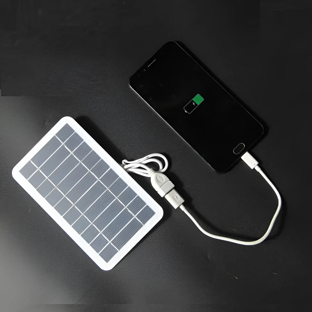 Portable solar panel charger measuring 157x94mm with USB cable for mobile device charging
