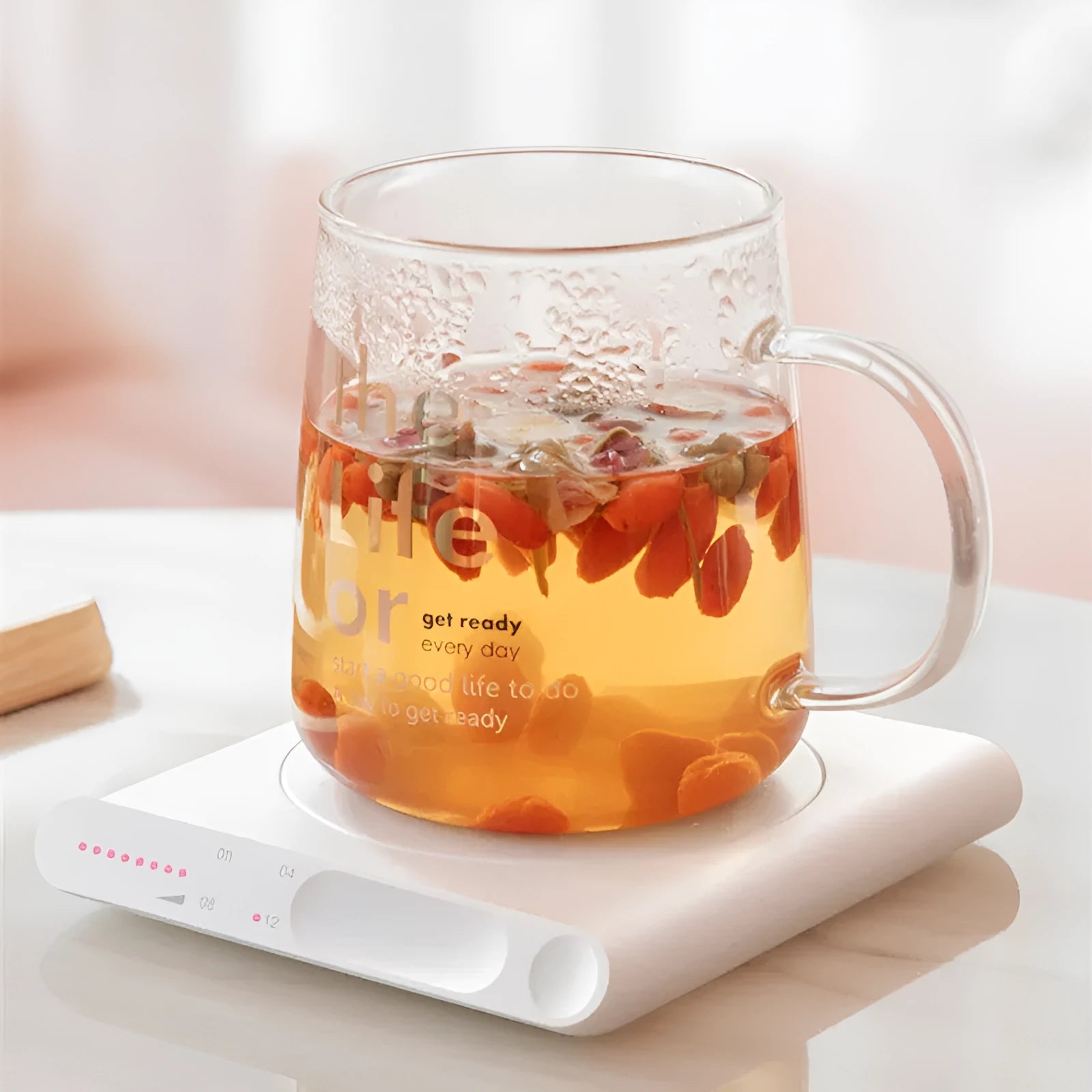 Pink and white USB heating cup pad with mechanical timer for keeping drinks warm