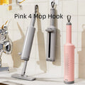 Pink self-squeezing rotatable mini flat mop with microfiber pad on a hardwood floor.