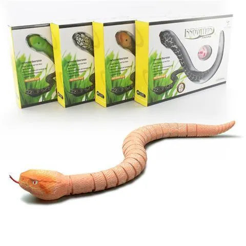 Novelty Remote Control Snake in green colour, 38 cm plastic toy with retractable tongue on a wooden floor