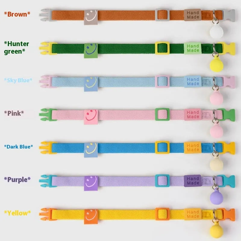 A small, elastic monochrome dog collar in sky blue with a plastic buckle, laid flat.