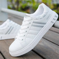 Classic black, gray and white mesh sports shoes with a cushioned midsole, shown from a side angle.