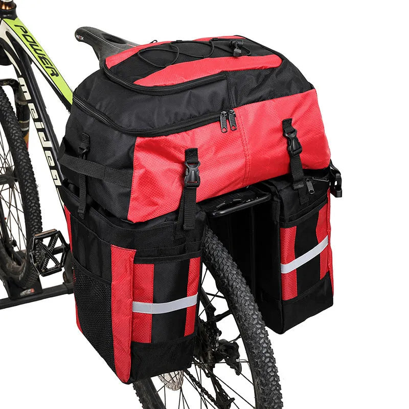 Green 70 litre bicycle rear storage frame bag mounted on a bike for touring.