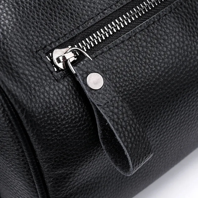 Black genuine leather one-shoulder crossbody bag showing dimensions and interior polyester lining
