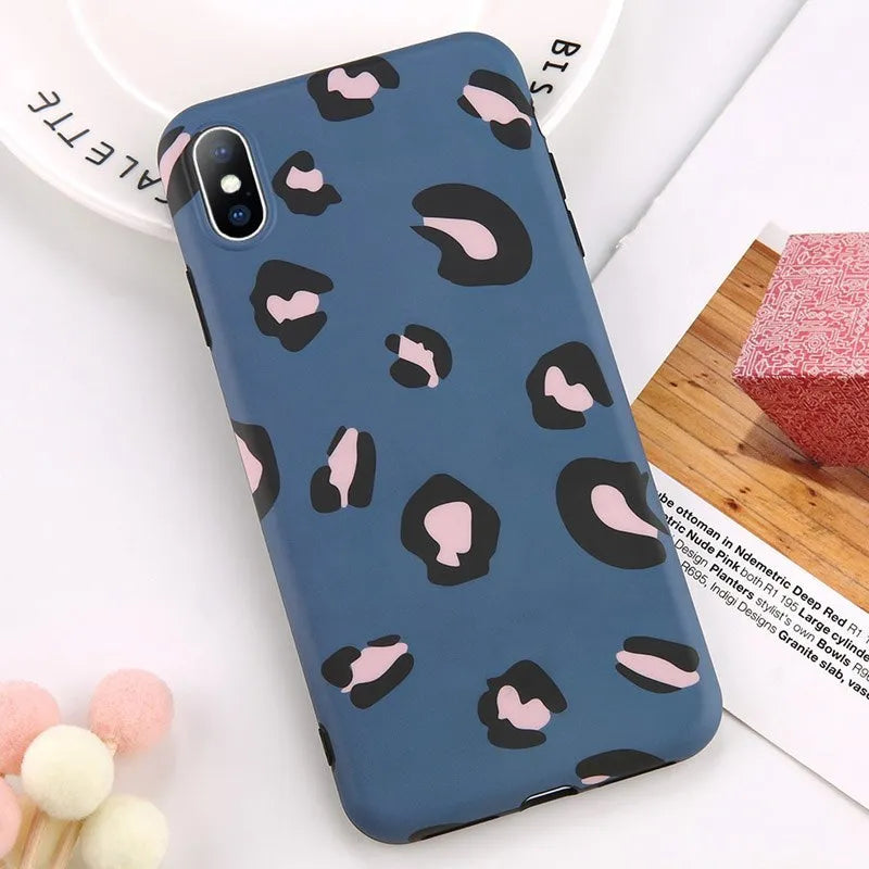 Leopard print protective mobile phone case for iPhone in black, blue, and pink colour options.