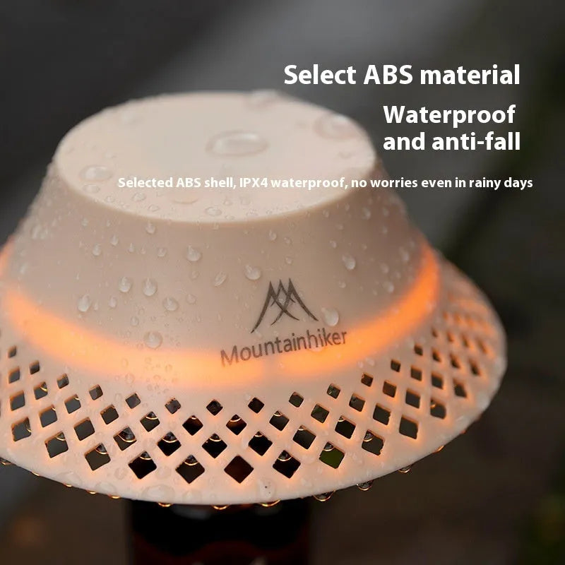 Beige fabric shade camping lantern on wooden table, powered by a repurposed wine bottle base with USB-C port.