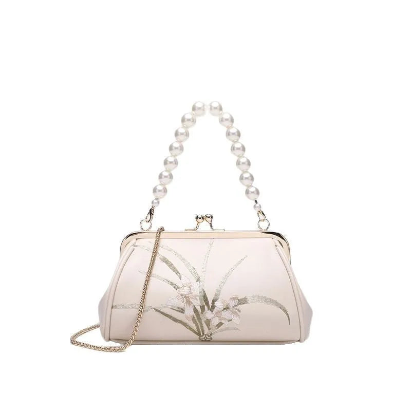 Beige shell-shaped women's shoulder bag with embroidery detail on soft PU leather.