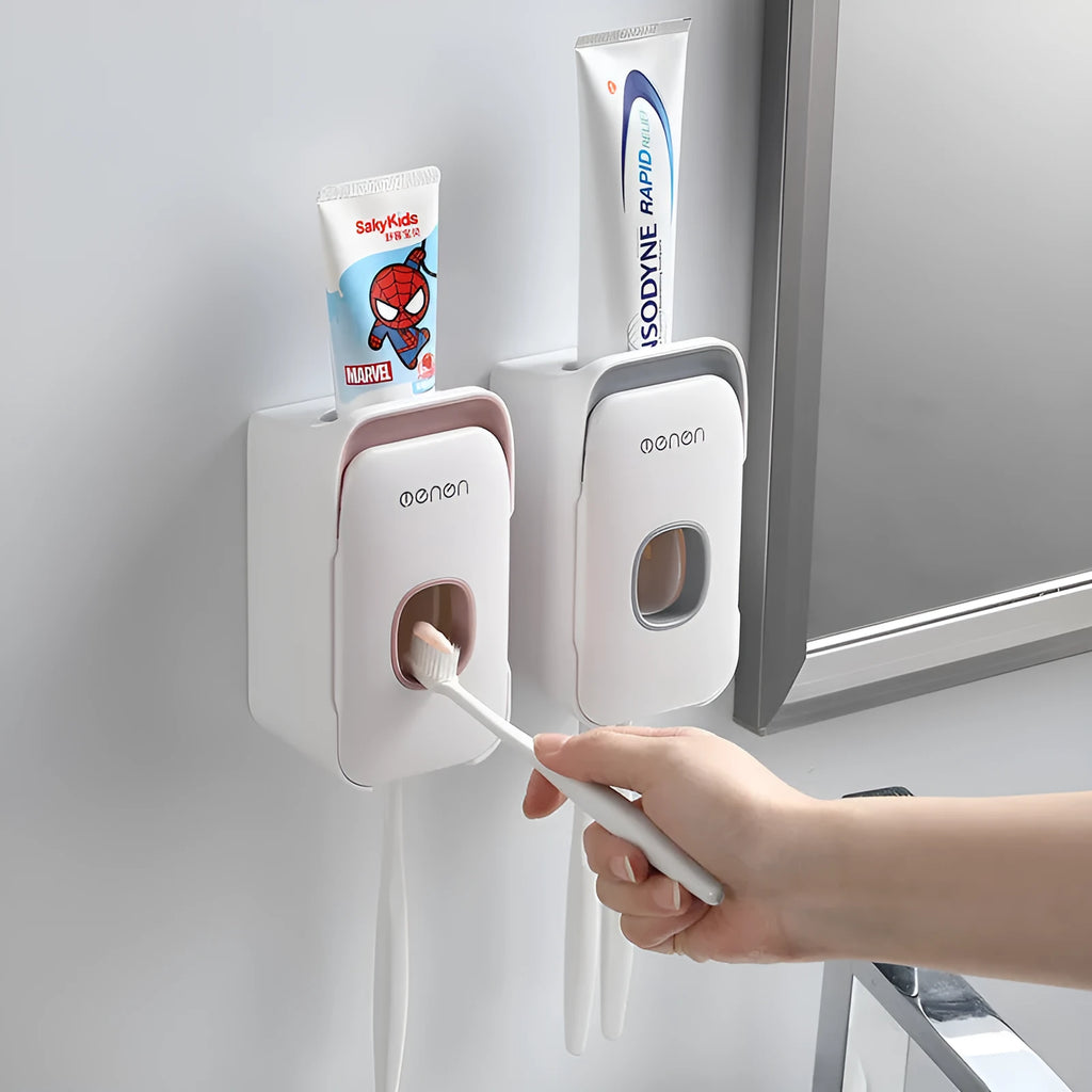 Blue, grey, and pink automatic toothpaste dispenser made of ABS plastic for wall mounting