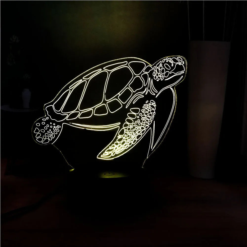3D sculpted green turtle LED night light glowing with multi-colours on a dark surface