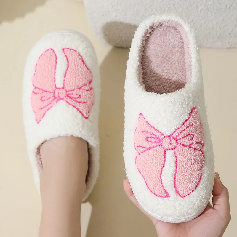 Pink and blue cartoon bow knot oversleeve slippers with suede upper and TPR sole.