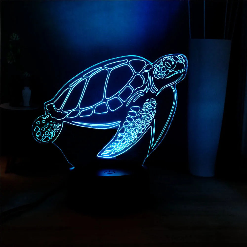 3D sculpted green turtle LED night light glowing with multi-colours on a dark surface