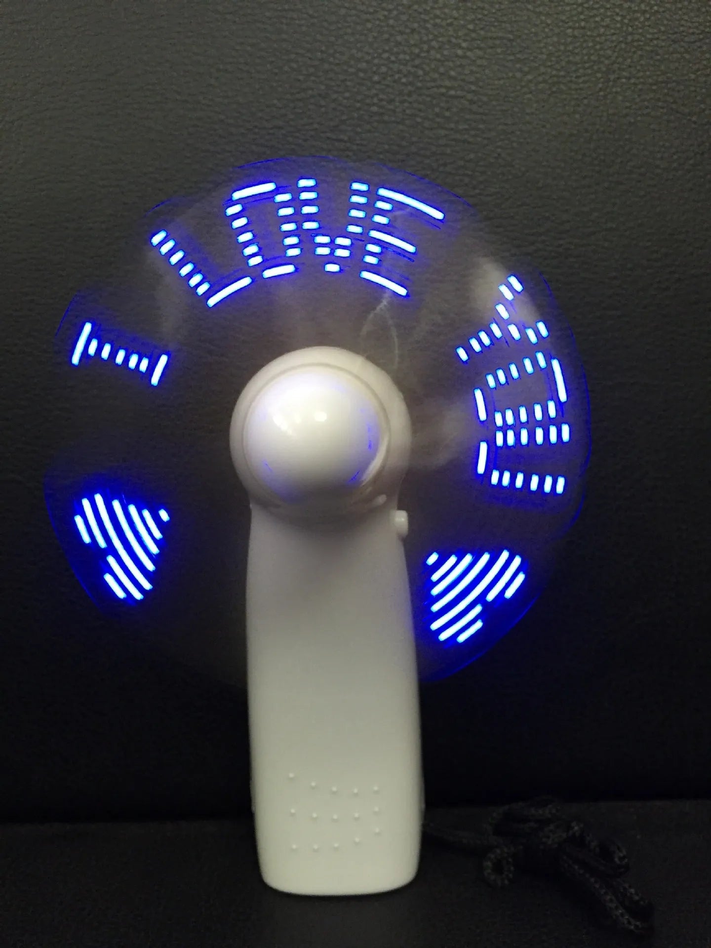 White handheld mini fan showing blue LED 'I Love You' pattern, dimensions 10.8cm.