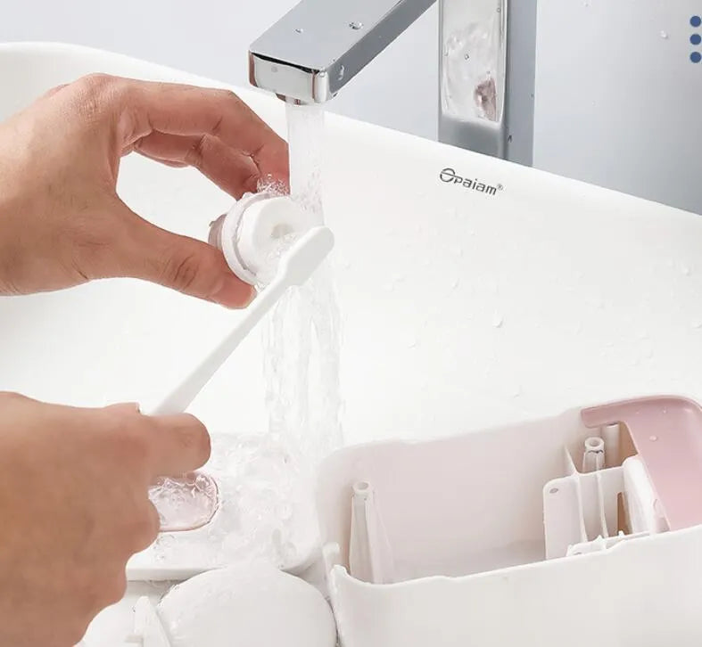 Blue, grey, and pink automatic toothpaste dispenser made of ABS plastic for wall mounting