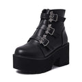 Black women's ankle boots with bat buckle, side zip, and thick heel.