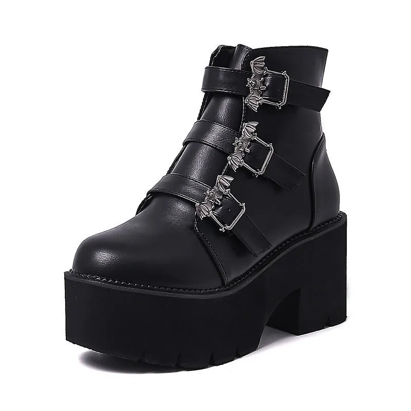 Black women's ankle boots with bat buckle, side zip, and thick heel.