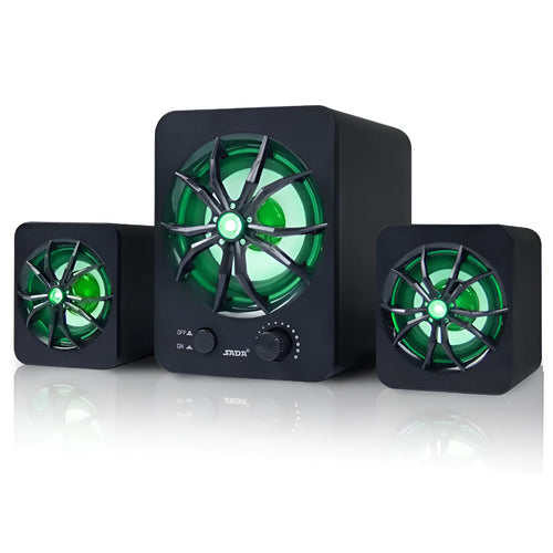 Green 2.1 USB computer speaker with LED lights on a desk next to a laptop.