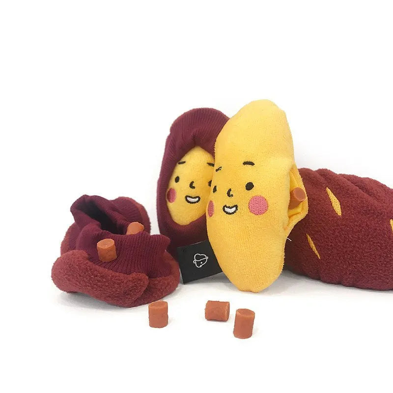 Red sweet potato pet toy with peelable exterior revealing hidden food pocket for treat dispensing