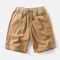 Men's khaki cargo shorts with multiple pockets showing retro American street style and straight-leg fit