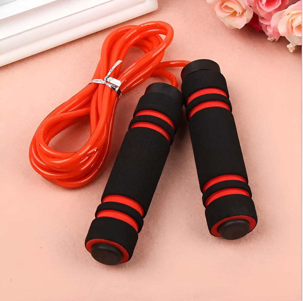 Adjustable jump rope with weighted black handles on a gym mat