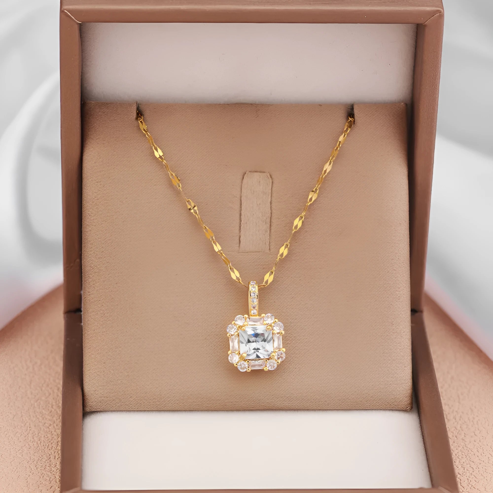 Geometric quadrilateral pendant necklace with mixed gem inlay on a gold titanium steel chain.