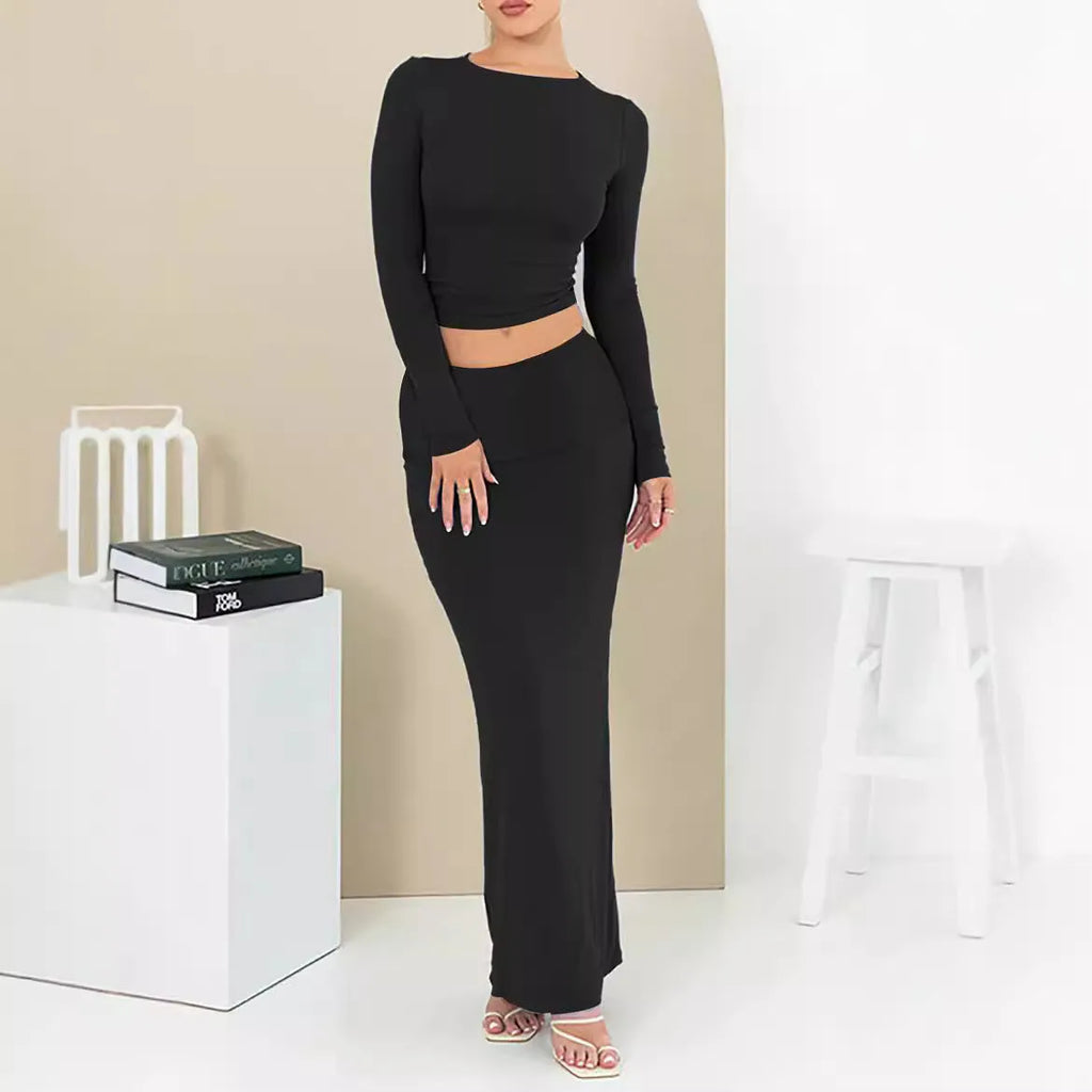 Women's black slim fit two-piece suit with exposed navel top and long skirt.