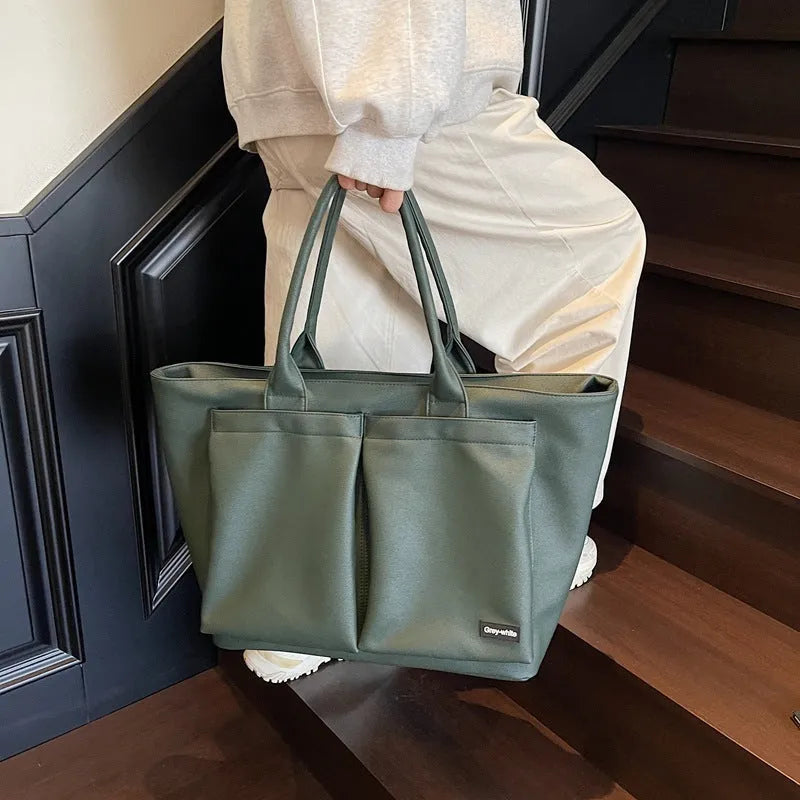Lightweight expandable shoulder bag in solid colour with ventilation feature