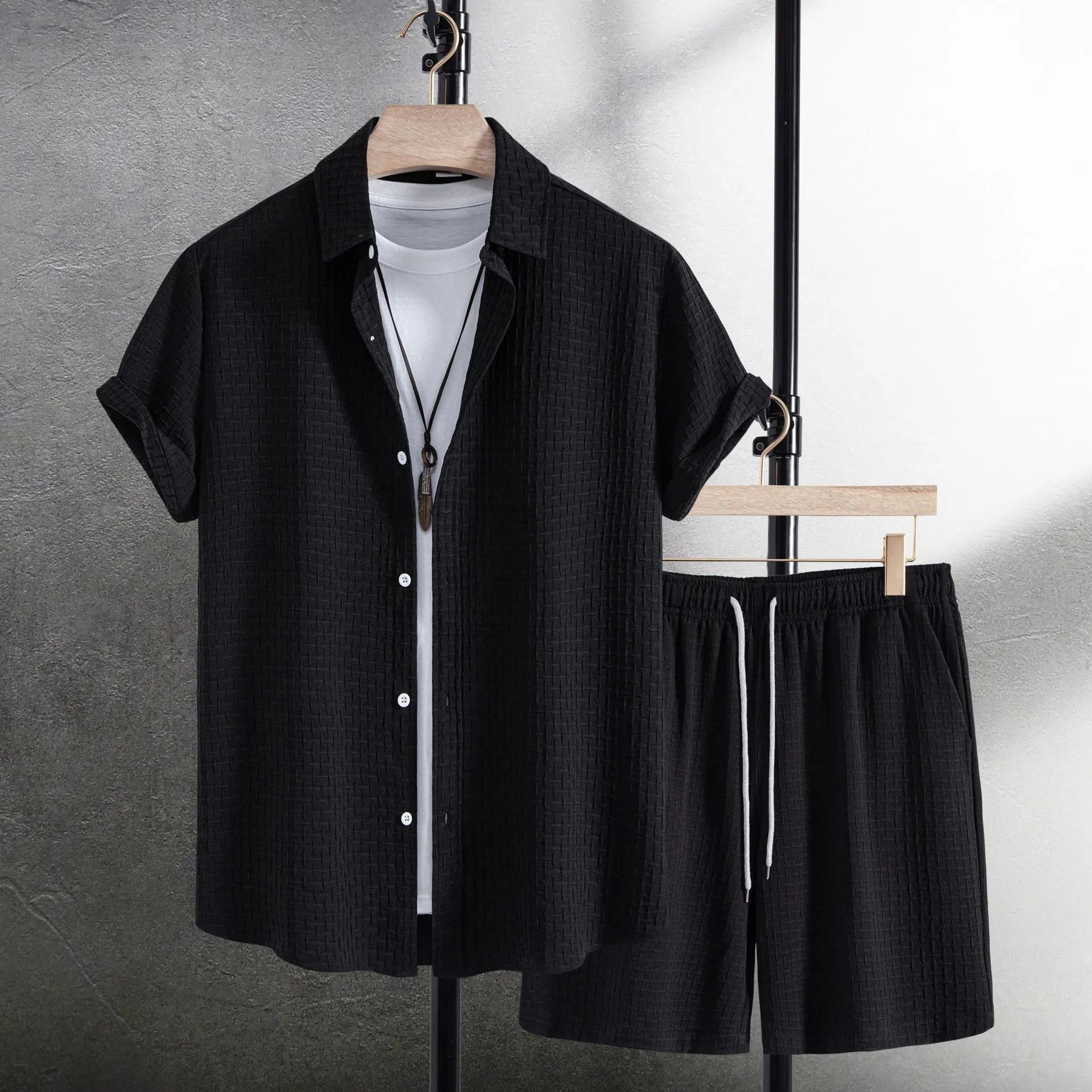 Men's white cotton blend beach shorts suit with short sleeve shirt on a hanger.