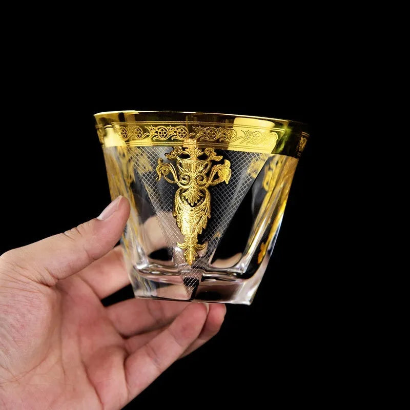 Crystal glass whisky tumbler set with gold line detailing, Nordic style, one wine bottle and six glasses on table