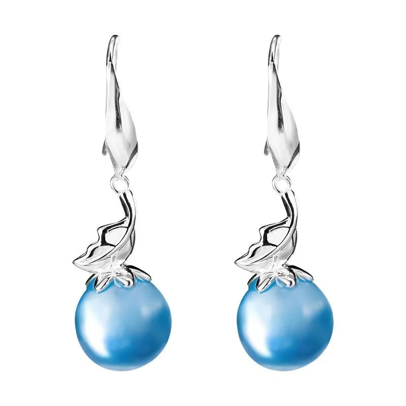A pair of vintage-style silver earrings featuring aquamarine leaf and four-petal flower designs.