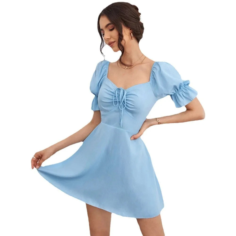 Sky blue flared A-line dress with puff sleeves and bow detail on a figure