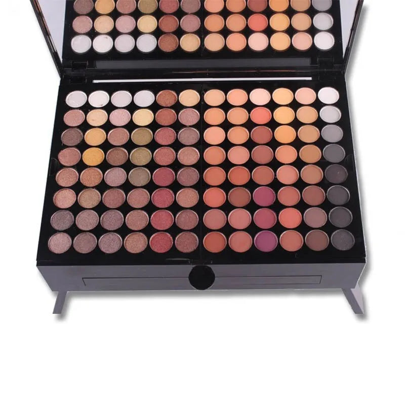 Piano-shaped makeup palette showing 180 colour eyeshadows, blushes, and powders in organised layout