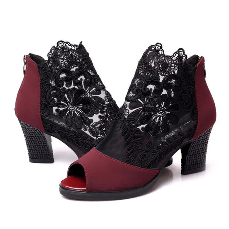 Women's black lace gladiator sandals with a square high heel and peep toe, showing zip closure